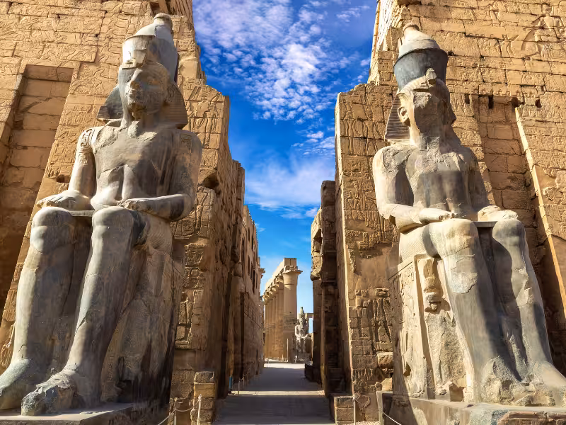 Colossal seated statues at Karnak Temple entrance in Luxor, a must-see on Egypt Highlights tour