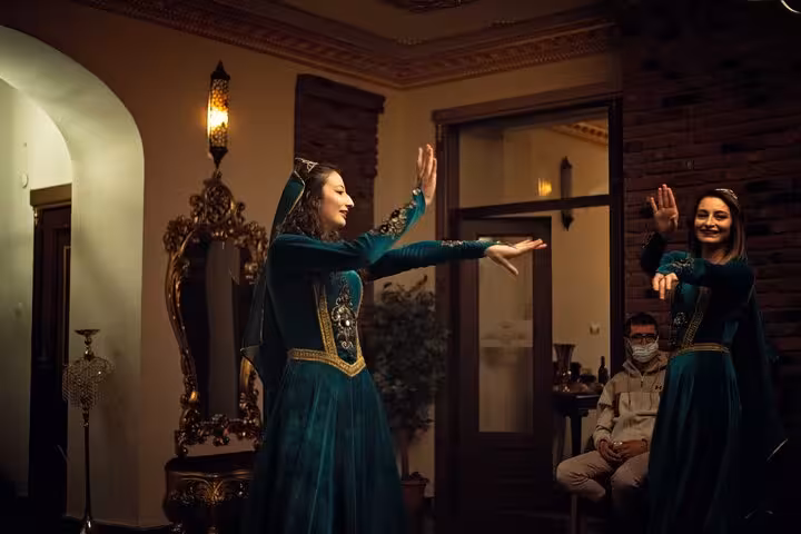 Women perform Caucasian folk dance in Kars at a heritage venue on a private guided city tour, Turkey