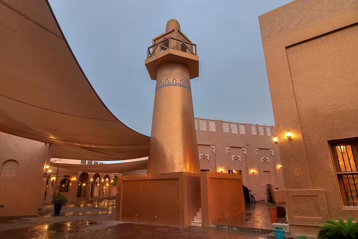 Golden minaret and architecture at Katara Cultural Village in Doha, highlighting rich Qatari heritage and art.