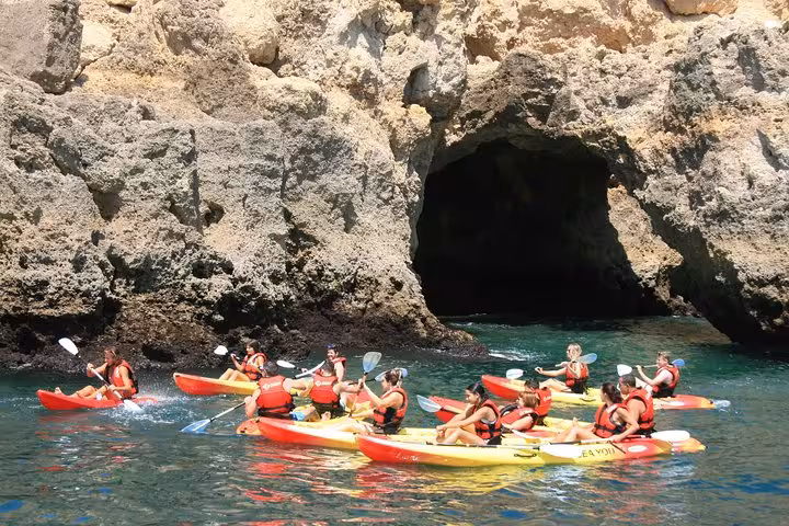 Kayakers enter a sea cave at Ponta da Piedade, Lagos Algarve, on a top-rated guided cave tour