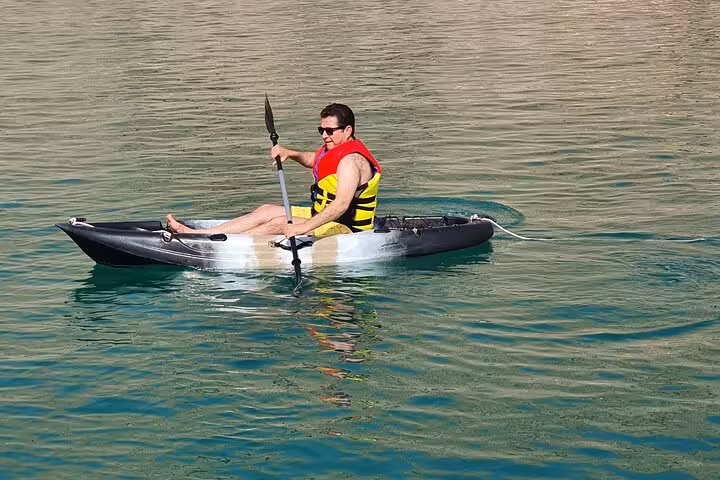 Kayaking on Hatta Dam turquoise lake during private full-day Hatta visit from Dubai, ideal for 1–6 pax