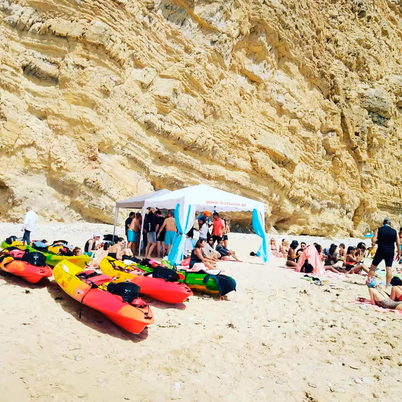 Kayaks lined up on a Sesimbra beach stop with tour base camp, ideal for canoeing and coastal activities in Portugal