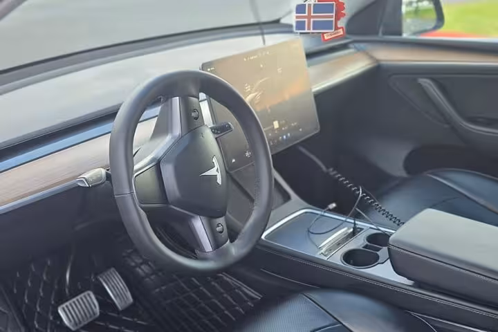 Modern interior of a luxury car for Keflavik Airport transfer, showcasing sleek design for travel to Reykjavik.