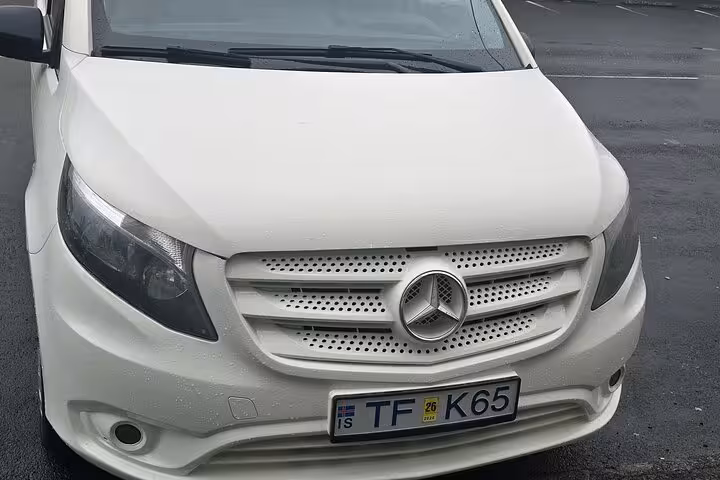 White Mercedes van ready for private transfer service from Keflavik Airport to Reykjavik.