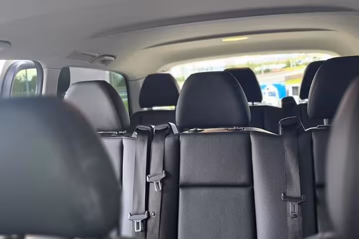 Spacious seating arrangement inside a private transfer van for comfortable travel between Keflavik Airport and Reykjavik.