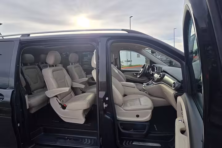 Luxurious private van interior for Keflavik Airport transfer to Reykjavik, featuring spacious leather seating.