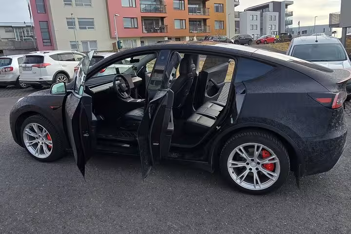 Black car with doors open, showcasing spacious interior for Keflavik to Reykjavik private transfer.