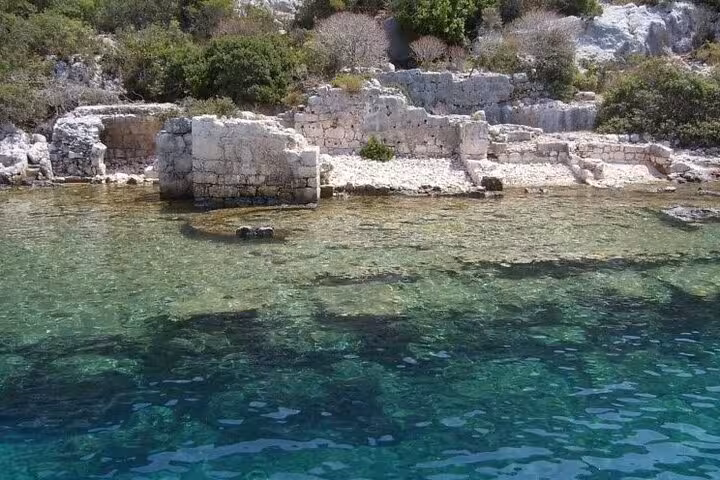 Kekova sunken ruins along the shoreline in turquoise sea, highlights of Myra St Nicholas Church boat tour