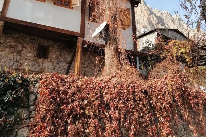 Traditional Kemaliye stone house with autumn vines, visited on an all-inclusive private 2-day tour from Erzincan