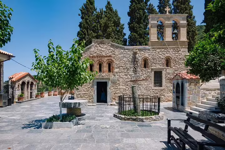 Historic Kera Monastery courtyard under a clear blue sky, featured on a private tour from Chania.
