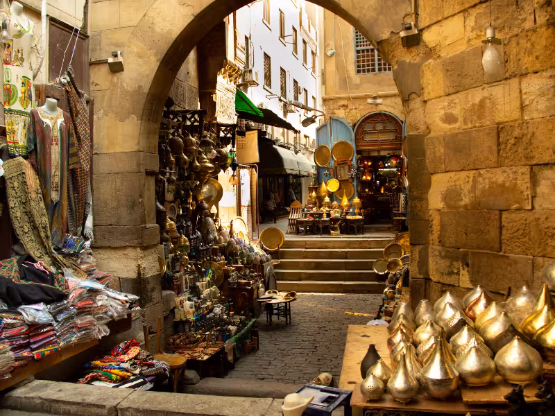 Khan el-Khalili bazaar alley with brass lanterns and textiles in Old Cairo, a stop on the Golden Cairo tour