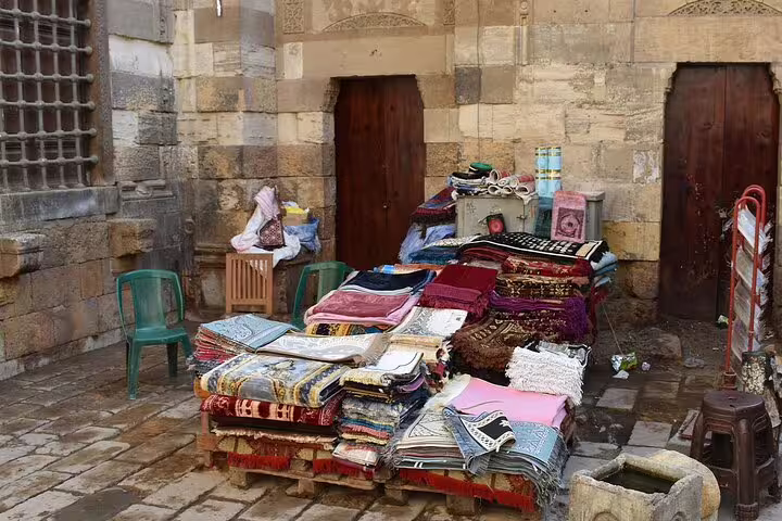 Khan El Khalili bazaar rug and textile stall in Old Cairo, ideal stop on a private 3-day Cairo Giza Alexandria tour