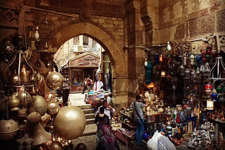 Bustling Khan El-Khalili bazaar in Islamic Cairo with brass lanterns and spice stalls on guided tour