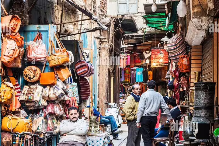 Khan El-Khalili bazaar alley in Cairo with leather bags and local vendors on guided city tour
