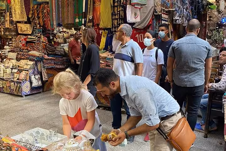 Travelers browse colorful Khan el-Khalili bazaar stalls in Cairo on a hidden gems culture and cuisine tour