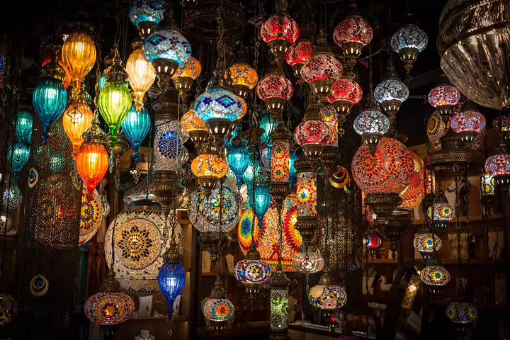 Colorful mosaic glass lanterns hanging in Khan El Khalili bazaar on a Medieval Cairo shopping tour