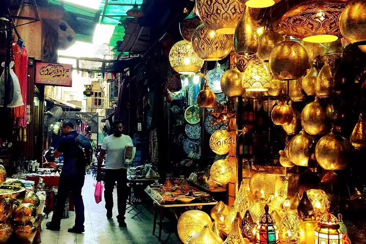 Shoppers under hanging mosaic lanterns in Khan El-Khalili Bazaar, Cairo, on Citadel and Coptic Cairo tour