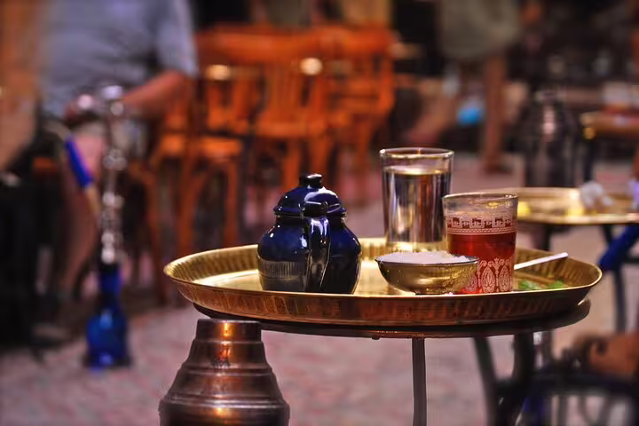 Traditional tea on brass tray at Khan El Khalili bazaar cafe in Old Cairo, perfect stop on Cairo day tour