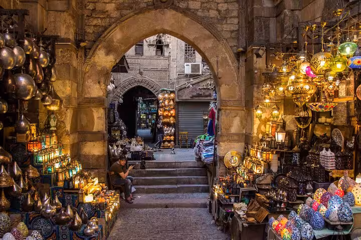 Colorful lantern shops under stone arch at Khan El Khalili, part of VIP 4-hour Islamic Cairo tour