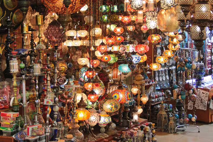 Crowded Khan El Khalili market stall with brassware and glowing lanterns on El-Moez Street tour