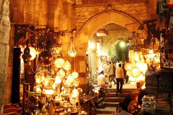 Khan El-Khalili market in Cairo glowing with brass lanterns under historic archway on evening tour