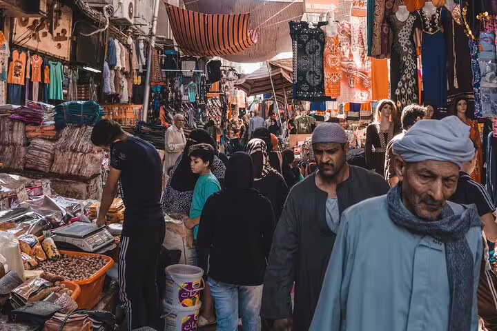 Crowded Khan El Khalili market lane with textiles and spice stalls during a 4-hour El-Moez Street tour