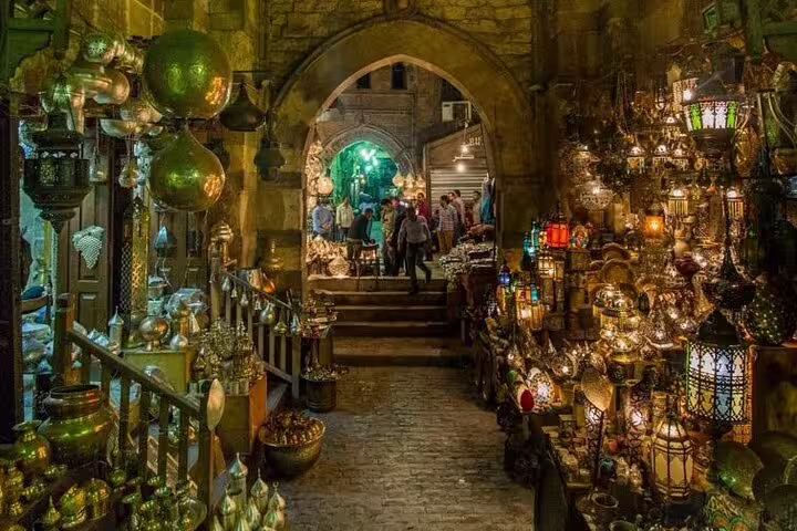 Evening view of Khan El-Khalili market corridor glowing with colorful lanterns on Cairo bazaar tour