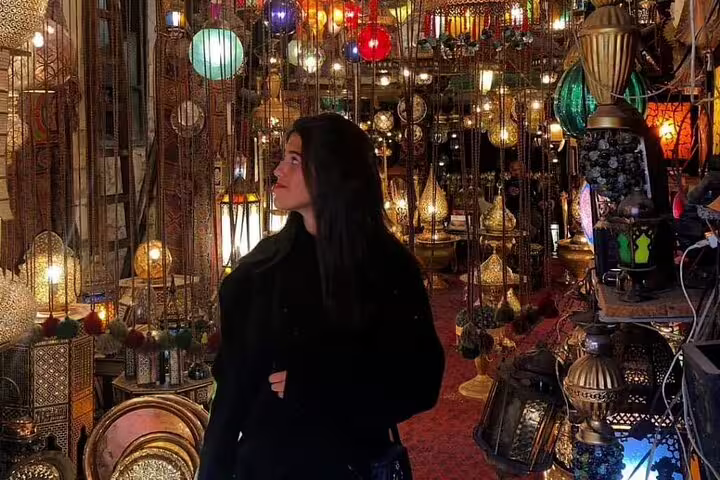 Traveler browsing colorful lanterns and crafts in Khan El Khalili Bazaar on a Cairo day tour shopping stop