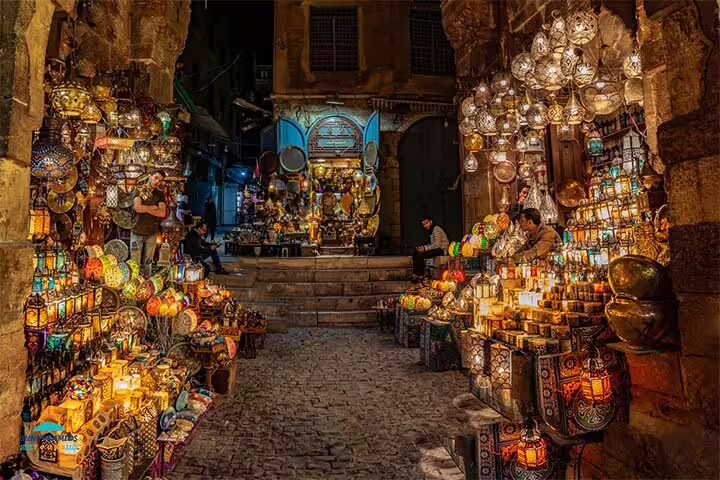 Khan El Khalili Bazaar alley glowing with colorful lanterns and brassware on an Old Cairo night tour