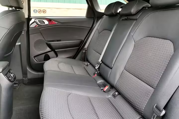 Interior of a Kia car showcasing comfortable back seats, perfect for private transfers to Lisbon and Lagos.