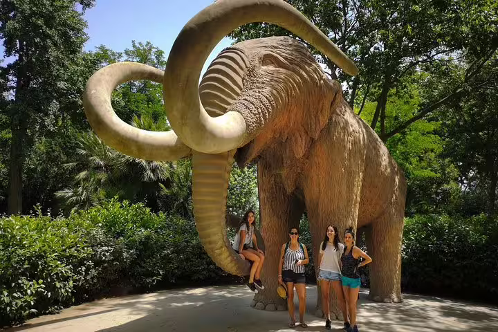 Tourists pose by the iconic mammoth sculpture in Ciutadella Park, a highlight of the Kickstart Barcelona Private Tour.