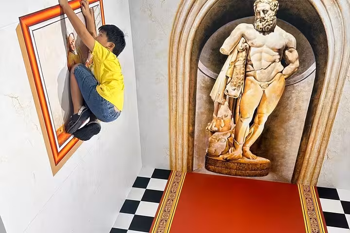 Kid posing with classical statue illusion at Trick Eye 3D Museum Sentosa Singapore entrance ticket