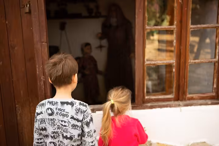 Kids exploring a traditional village house on Ephesus shore excursion from Kusadasi Port, family-friendly tour