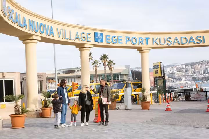 Family meeting guide at Kusadasi Port entrance, starting a kid-friendly Ephesus shore excursion from cruise