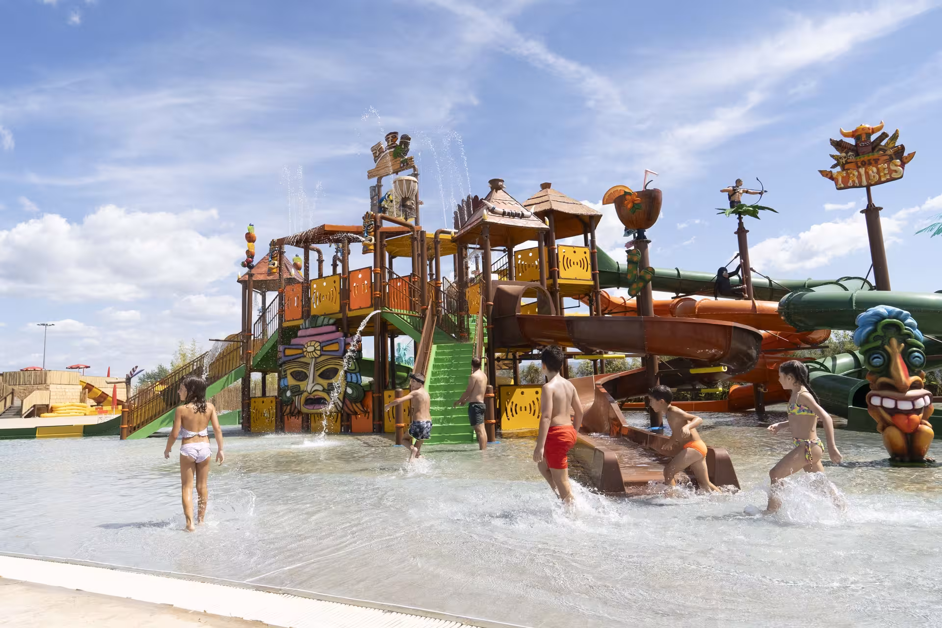 Kids play at MagicSplash water park near Rome on tribal-themed slides and splash zone, perfect family day out