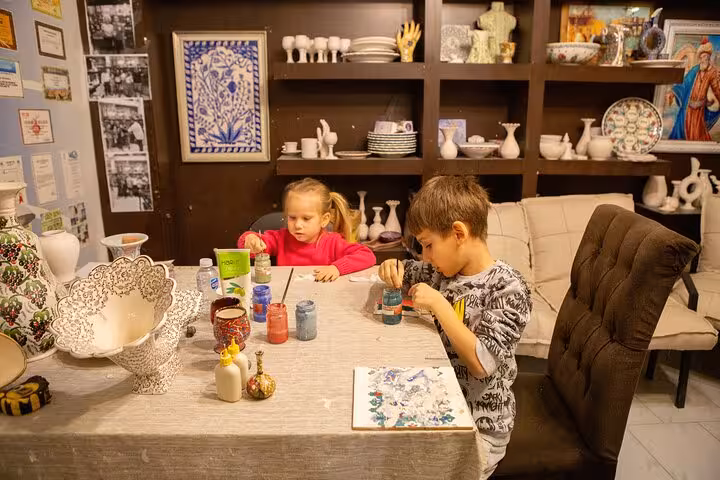 Kids doing pottery painting workshop on Ephesus shore excursion from Kusadasi Port, Turkish ceramics studio