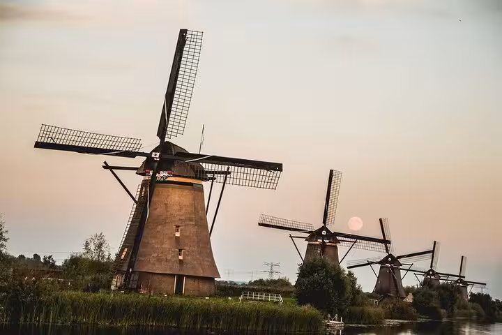 Kinderdijk windmills at sunset on a Famous Holland tour from Amsterdam, a classic Dutch UNESCO countryside stop