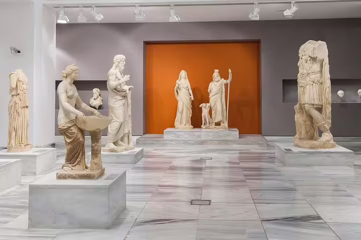 Ancient Greek statues on display at Heraklion Archaeological Museum, showcasing the rich history of Knossos Palace on a private tour.