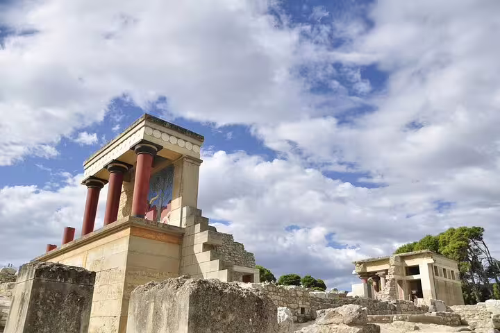 Explore the ancient ruins of Knossos Palace under a bright blue sky on a private tour including the Archaeological Museum and Heraklion Town.