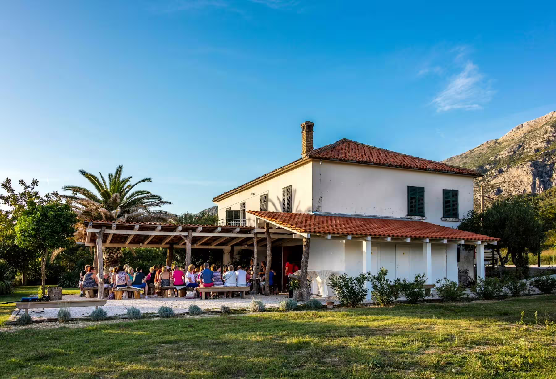 Traditional Konavle winery terrace near Dubrovnik hosting group wine tasting, part of the Konavle Valley train tour