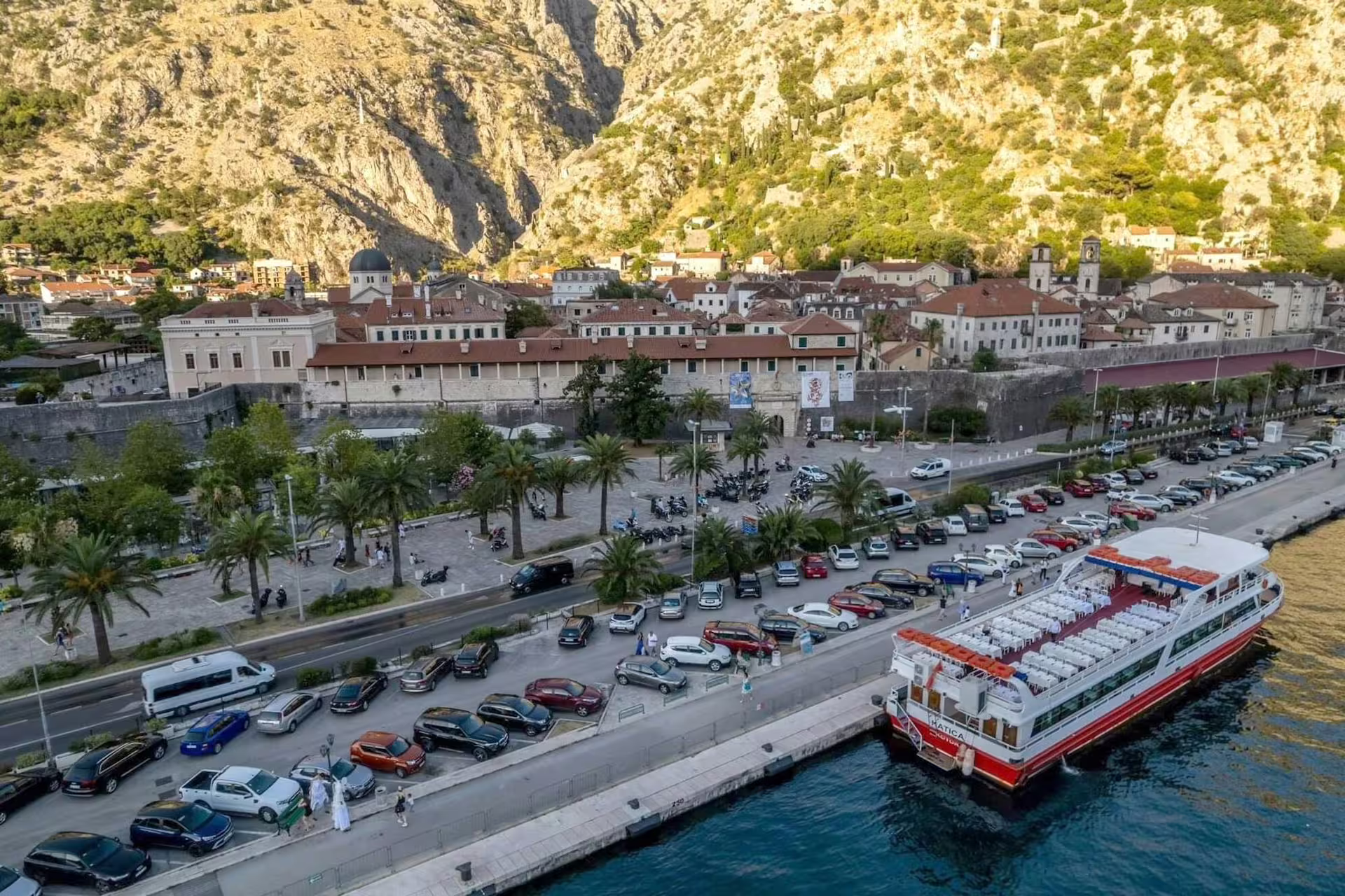 Kotor port and old town walls with cruise boat docked, Bay of Kotor cruise excursion from Dubrovnik