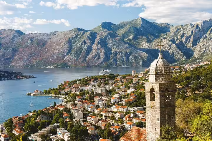 Kotor Bay viewpoint with historic church bell tower and mountains, private Trebinje to Montenegro car tour
