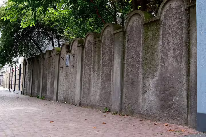 Krakow Jewish Quarter ghetto wall memorial along sidewalk, key stop on a private half-day Krakow sightseeing tour