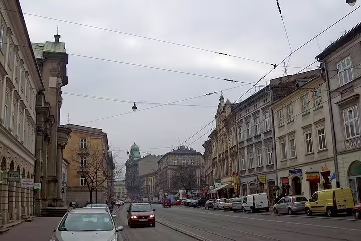 Street view in Krakow Old Town with historic buildings and tram lines on a private half-day sightseeing tour