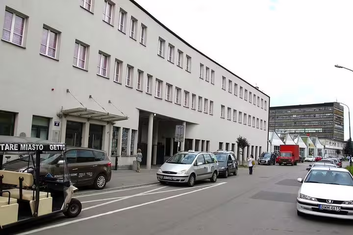 Krakow street with hotel pickup area and tour vehicles for a private half-day sightseeing tour in the city