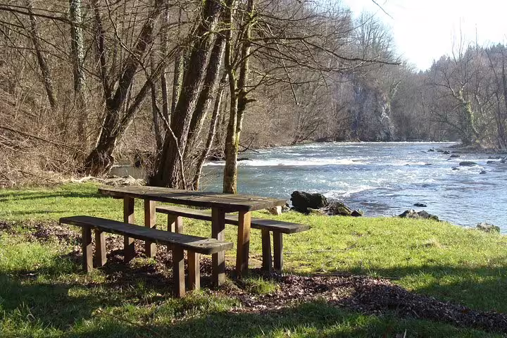 Riverside picnic area beside Krka River rapids, peaceful stop on Krka National Park and Waterfalls Tour