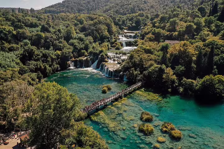 Aerial view of Krka Waterfalls boardwalk over turquoise pools on a private tour from Split, Croatia