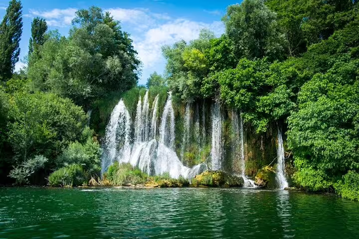 Lush Krka Waterfalls cascading into emerald pools, highlight of a private shore excursion from Split