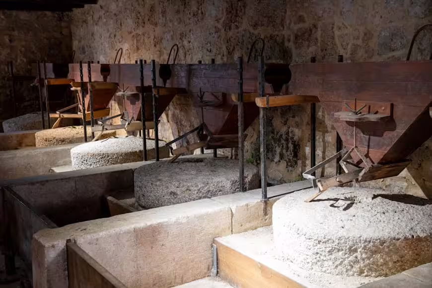Historic watermill with stone grinding wheels at Krka National Park, cultural stop on a private Krka Waterfalls tour
