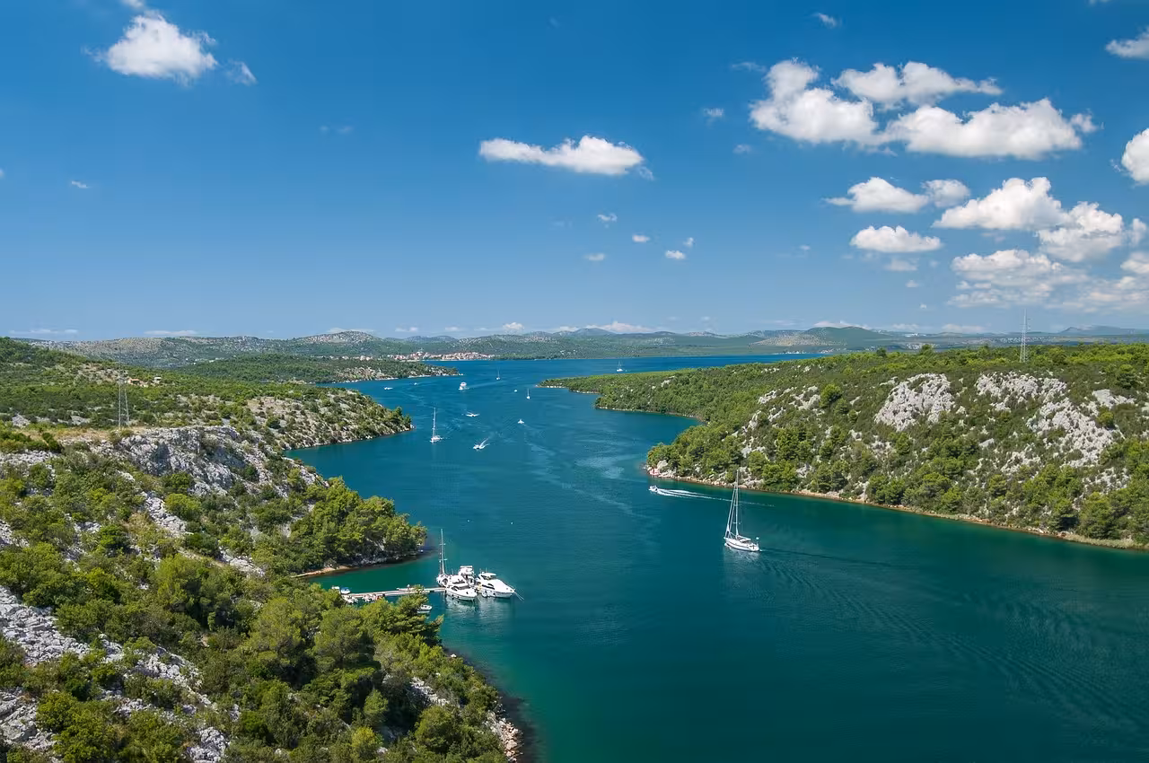Scenic Krka River canyon near Skradin with sailboats, a highlight on the Krka Waterfalls day trip from Zadar